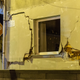 Cracks are seen on a wall of a damaged house in Fleri, Sicily Italy, Wednesday, Dec. 26, 2018. A quake triggered by Italy's Mount Etna volcano has jolted eastern Sicily, slightly injuring 10 people and prompting frightened Italian villagers to flee their homes. (AP Photo/Salvatore Allegra)